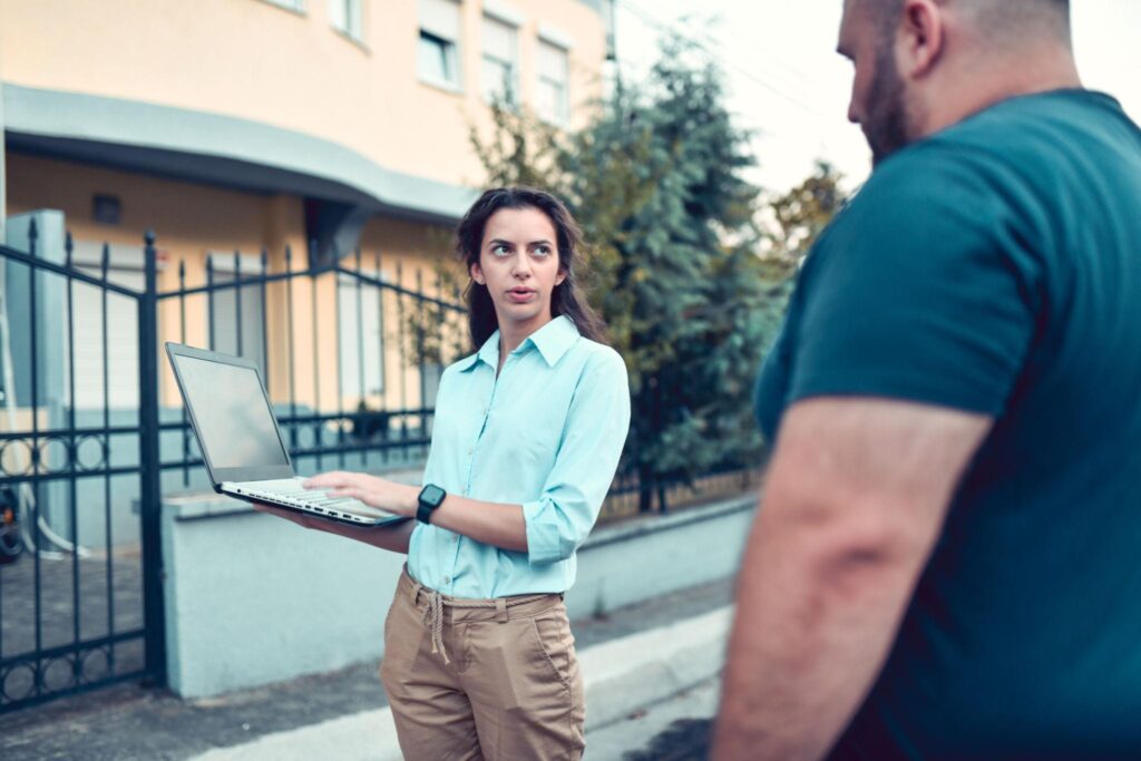Owner documenting building damage with Insurance Agent