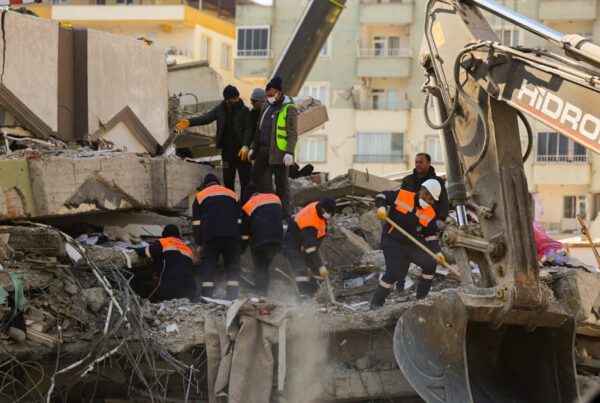 men checking the building collapse